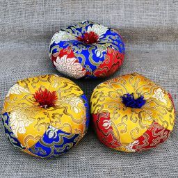 Singing bowl cushion - red/gold with blue tassels